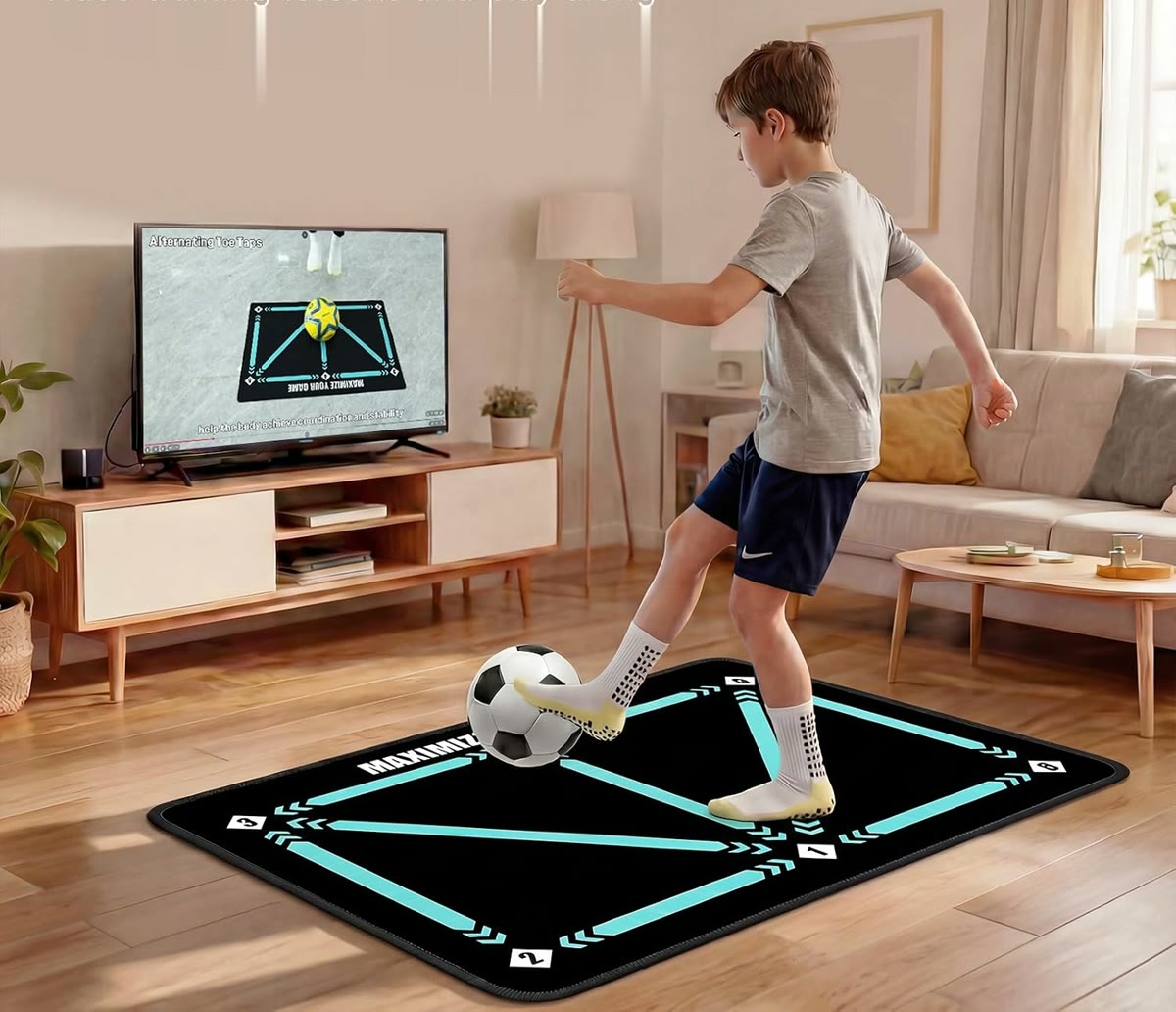 Following a football lesson on the TV while practicing on the mat